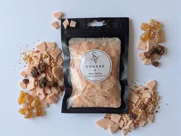 Wax Melts Sovaré Frankincense & Myrrh; peach-colored wax chunks in a black bag with a clear window.