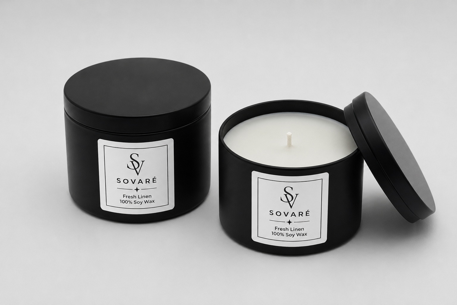 Assorted black candle jars with white labels arranged on a gray concrete floor.